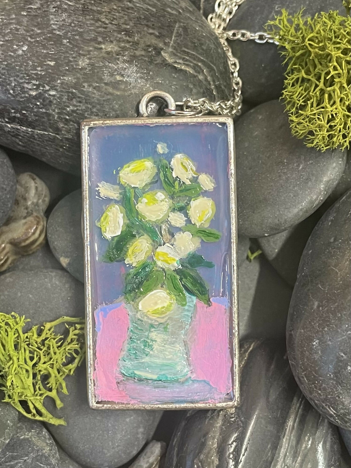 Creamy flowers in a vase on a pink and purple background. Pendant