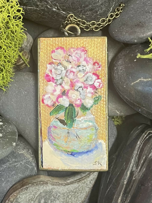 Round glass vase with white and pink flowers, pendant