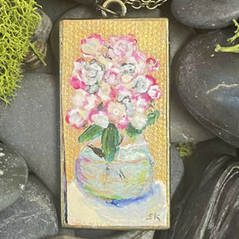 Round glass vase with white and pink flowers, pendant