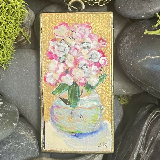 Round glass vase with white and pink flowers, pendant